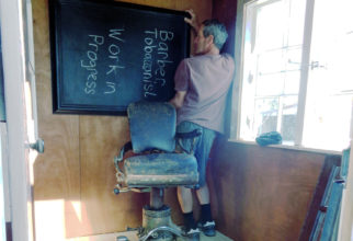 Scott tries different mirror sizes for our barber shop.