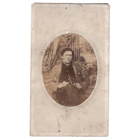 CdV of Man Sitting in Front of Photographic Background (ANPH-021)