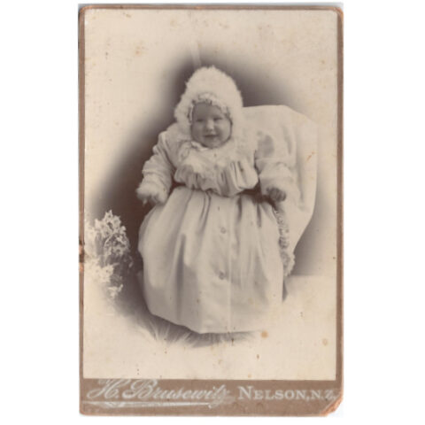 Cabinet Card of a Baby Smiling by H Brusewitz Nelson (ANPI-010)