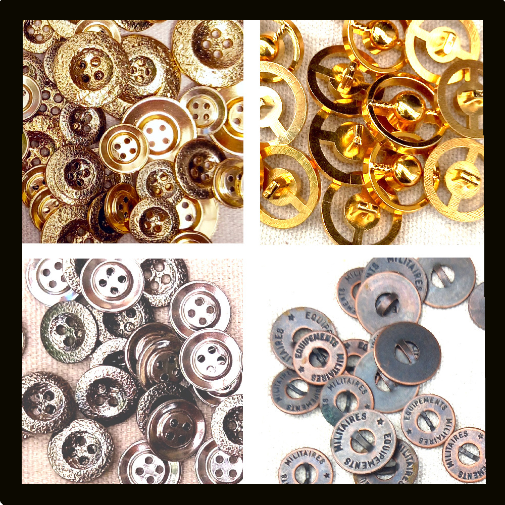 Collection of vintage silver and gold buttons made of metal and plastic displayed on a wooden surface