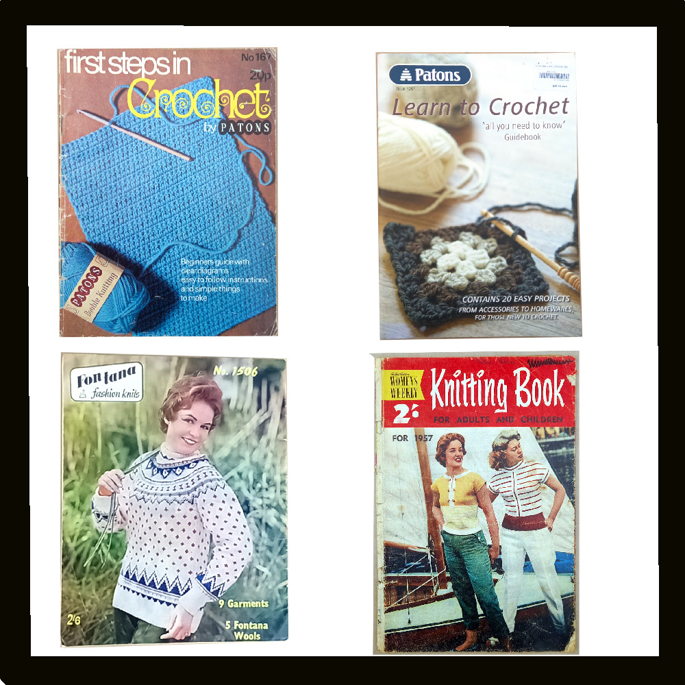 Collection of knitting and crochet books with yarn, needles, and hooks arranged on a crafting table