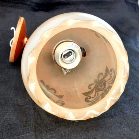 retro wall lamp with frosted globe glass shade providing soft ambient light in a vintage style