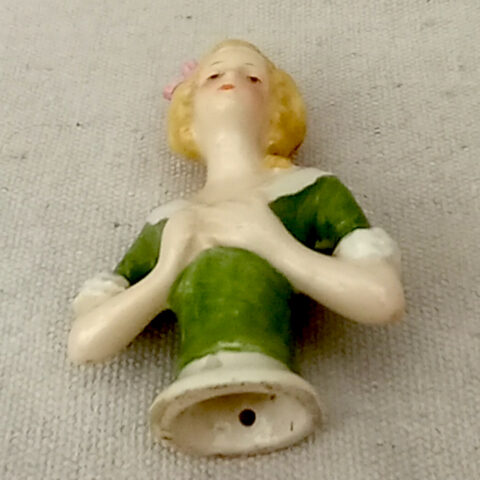 Vintage porcelain half doll figurine with detailed hair and painted features, decorative collectible doll bust.