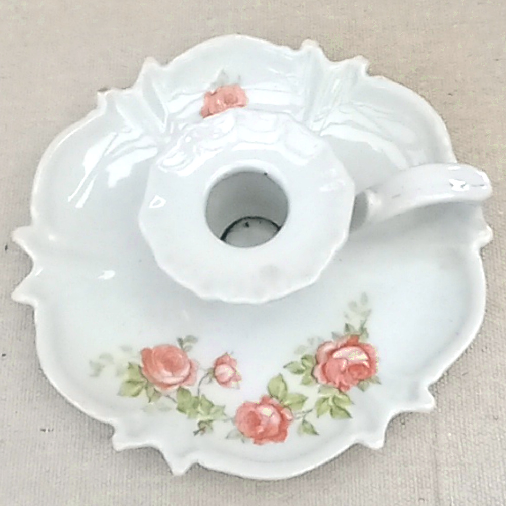 Porcelain chamberstick candle holder by Victoria with flat base, handle, and candle socket in classic vintage style