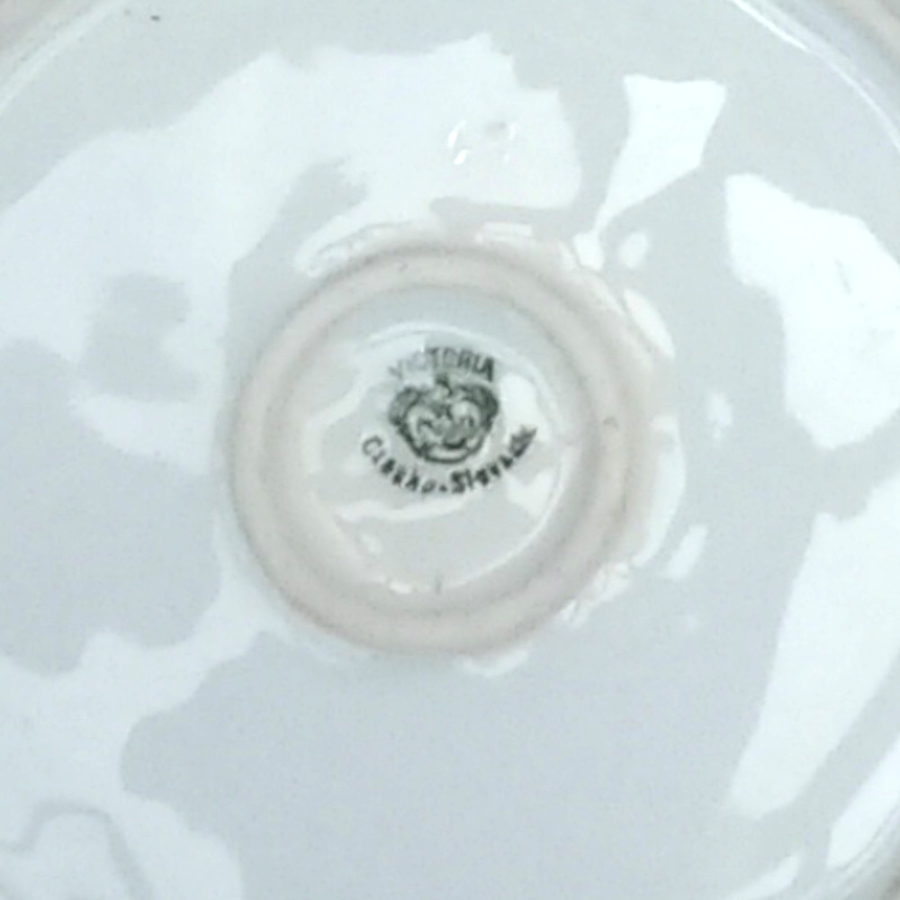 Porcelain chamberstick candle holder by Victoria with flat base, handle, and candle socket in classic vintage style