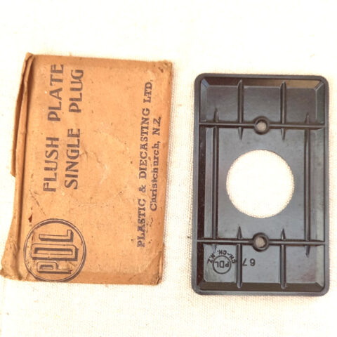 Vintage PDL Bakelite flush plate for single plug outlet in new old stock condition