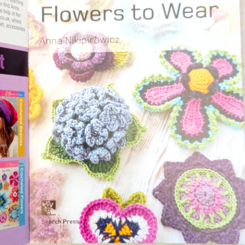 20 Crocheted Flowers to Wear book by Anna Nikipirowicz showing colorful crochet flower accessories and patterns