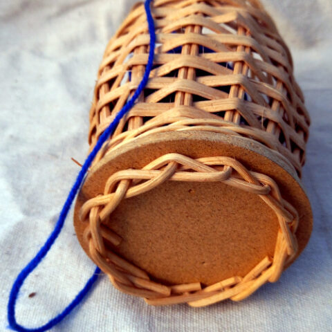 Vintage-style wicker holder designed for storing wool or string, featuring a rustic woven texture and classic retro look.