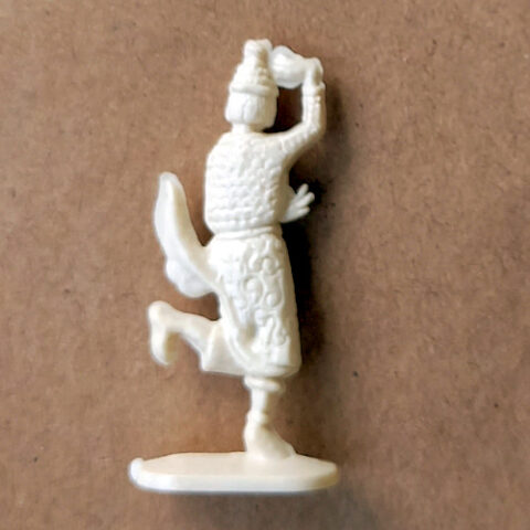 Vintage margarine figurine of a Bali dancer with detailed costume and pose close-up