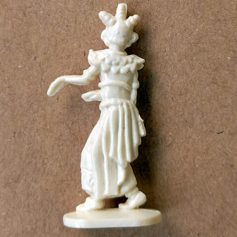 Vintage margarine figurine of a Bali dancer in traditional Indonesian costume close-up