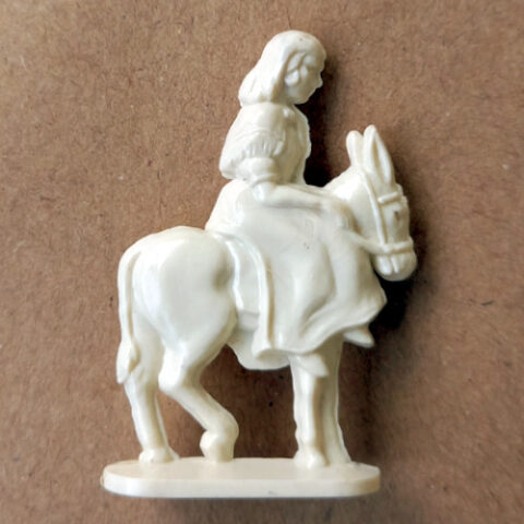 Vintage 1950s margarine figurine of woman riding a donkey sideways in retro style with molded detail