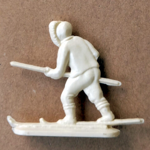 Vintage margarine figurine of a hunting Eskimo with traditional Arctic clothing close-up