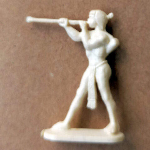 Vintage margarine figurine of a blowgun hunter with detailed tribal features and retro design