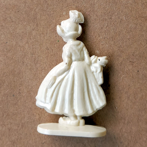 Vintage margarine figurine of a traditional Dutch woman wearing classic attire and bonnet