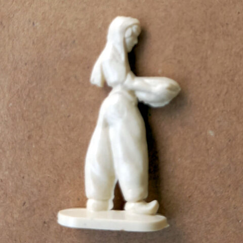 Vintage margarine figurine of a woman wearing harem pants in a detailed retro collectible design