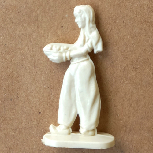 Vintage margarine figurine of a woman wearing harem pants in a detailed retro collectible design
