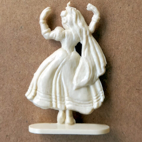 Vintage margarine figurine of a female dancer in a graceful pose close-up