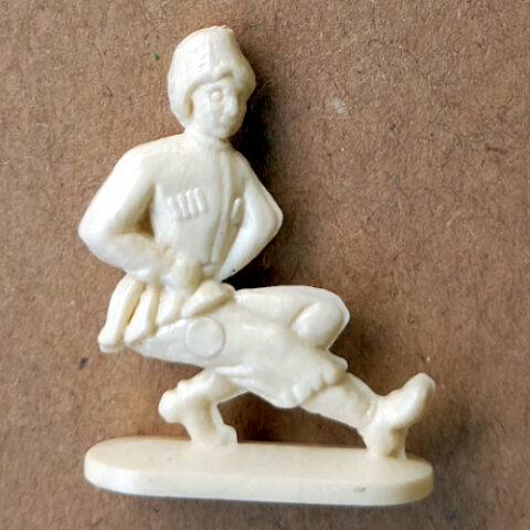 Vintage margarine figurine of a dancer in traditional folklore costume mid-dance pose