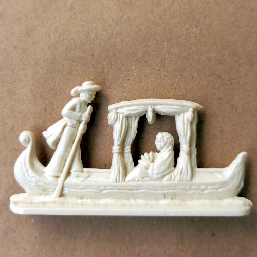 Vintage margarine figurine of a Venetian gondola with gondolier in traditional attire