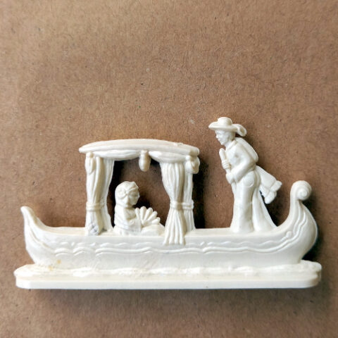 Vintage margarine figurine of a Venetian gondola with gondolier in traditional attire