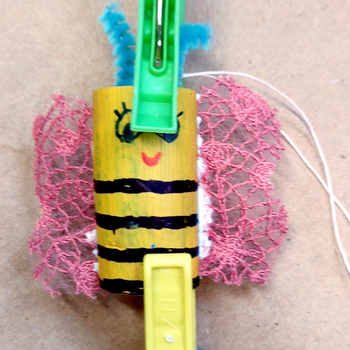 Bee made out of cork craft figure with painted black and yellow stripes and small wings
