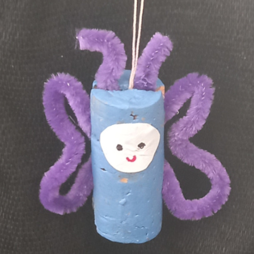 Handmade cork butterfly craft made from painted cork halves and pipe cleaner wings