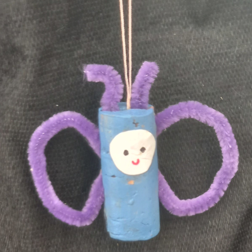 Handmade cork butterfly craft made from painted cork halves and pipe cleaner wings
