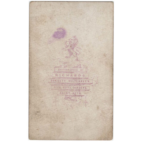 Carte de visite photograph of a standing woman by Richards Bransty & Whitehaven in Victorian studio portrait setting