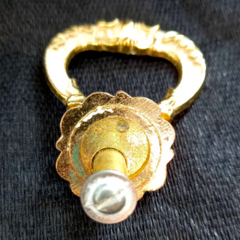 Retro Drawer Pull Handle by Turner in vintage metal finish mounted on a wooden cabinet drawer