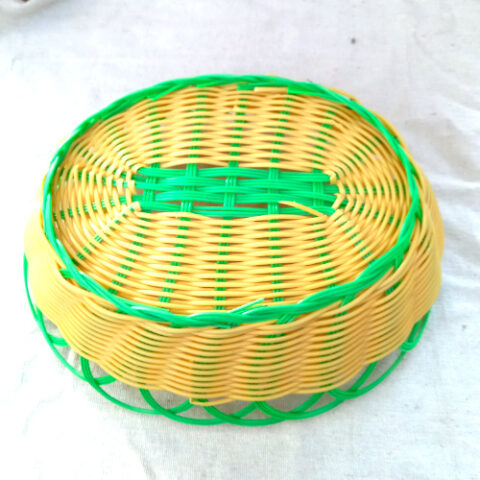 Retro plastic wicker fruit basket in yellow and green with woven design, ideal for kitchen storage and decorative fruit display.