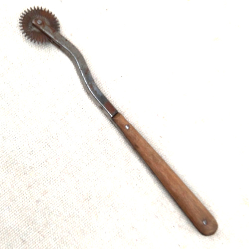 Vintage wooden handled pattern tracing wheel used for sewing and dressmaking fabric marking