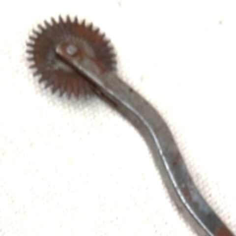 Vintage wooden handled pattern tracing wheel used for sewing and dressmaking fabric marking