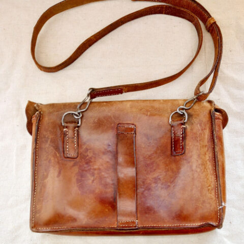 Funky vintage leather bag with adjustable straps, multiple compartments, and belt attachment option