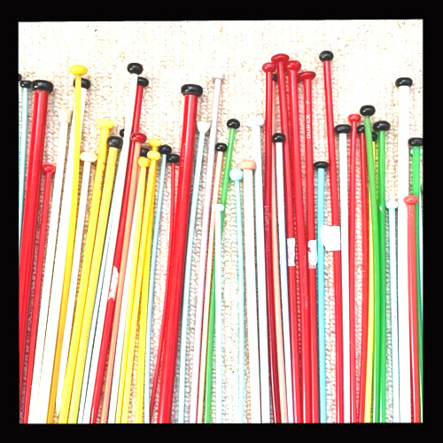 Vintage knitting accessories including needles, gauges, and knitting tools