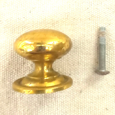 Heavy-duty brass-coated classic round drawer knob fitted to a wooden cabinet drawer.