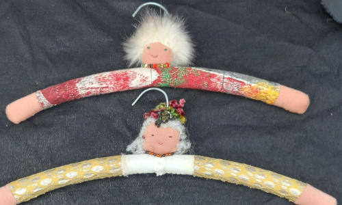 Old wooden clothes hanger transformed into a fun hanger with a sewn face and arms