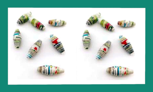 Colourful handmade paper beads used for jewellery and decorative crafts.