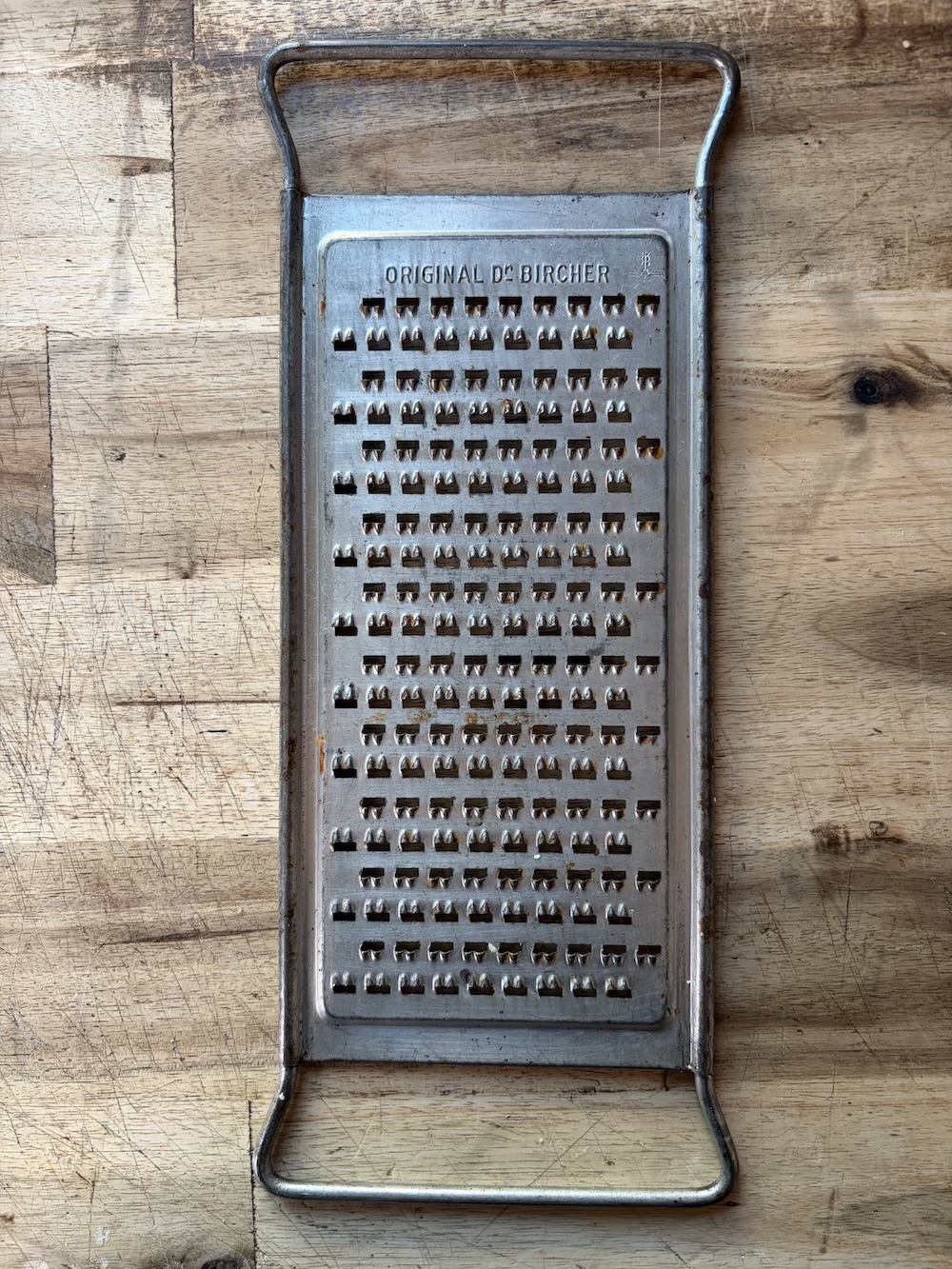 Traditional Swiss Bircheraffle apple grater used for preparing grated apples in Swiss cuisine