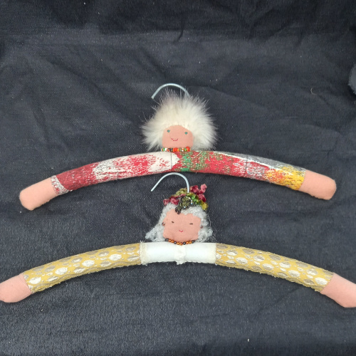 Old wooden clothes hanger transformed into a fun hanger with a sewn face and arms