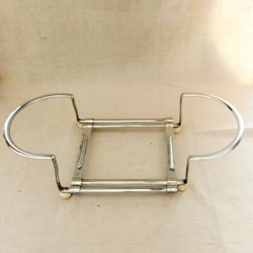 Vintage Swiss Extensio extendable metal hot pot carrier and trivet holder with patent O.H.Z. Brevete marking, mid-century kitchen accessory.