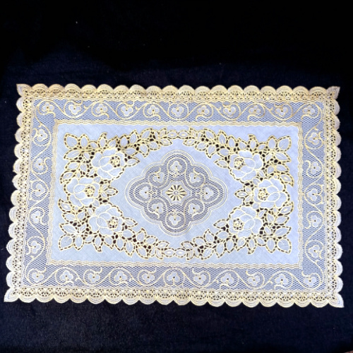 Vintage cream and gold plastic doily measuring 300 x 450mm with decorative lace pattern
