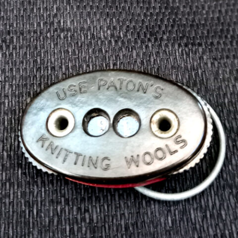 Vintage Patons flat knitting row counter with two rotating number discs and swivel finger ring.