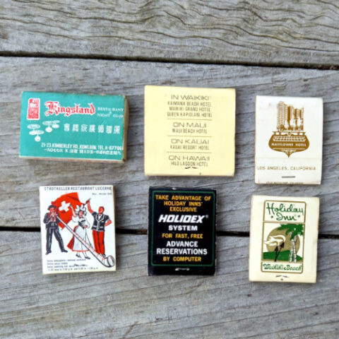 Six vintage advertising matchbooks with original matches featuring colorful retro business advertisements.