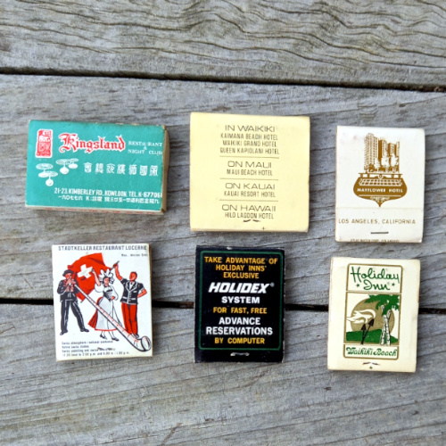 Six vintage advertising matchbooks with original matches featuring colorful retro business advertisements.