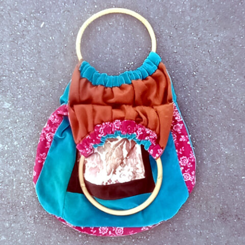 Retro patchwork handbag with colourful fabric panels and natural bamboo handles
