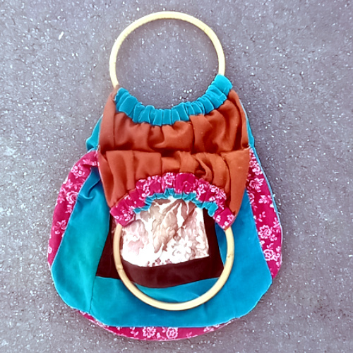 Retro patchwork handbag with colourful fabric panels and natural bamboo handles