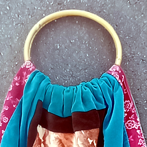 Retro patchwork handbag with colourful fabric panels and natural bamboo handles
