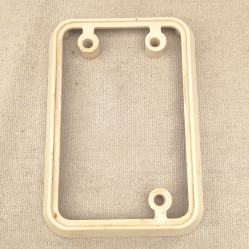 Vintage white Bakelite mounting block by PDL for electrical switch or socket installation.