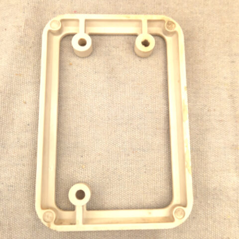 Vintage white Bakelite mounting block by PDL for electrical switch or socket installation.