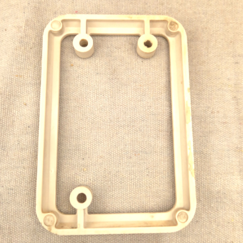 Vintage white Bakelite mounting block by PDL for electrical switch or socket installation.